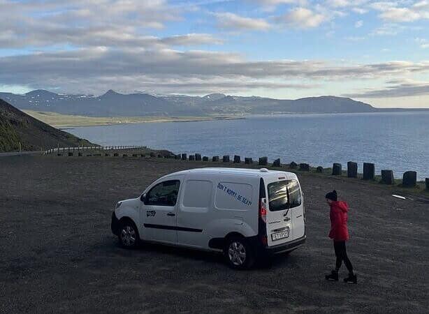 Me outside the campervan at a pitstop overlook with ocean views.