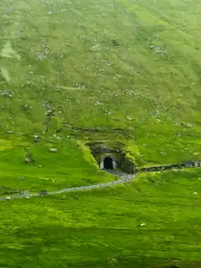 A one lane tunnel on Kalsoy island that goes through a mountain.