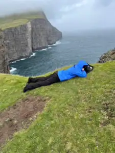 Me laying down on the Traelanipa hike which is also called the floating lake due to the image of a lake above the ocean.