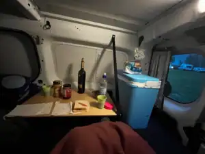 In the back of the van laying down on the bed with the little table down ready to eat some PB and Js and pour some wine and then off to sleep.