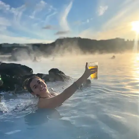 Soaking in the blue lagoon during sunset with a beer in my hand.