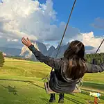 On a swing in Alpe di Siusi, Dolomites