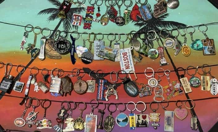 Key chain display on a painted canvas from all the places i visited.